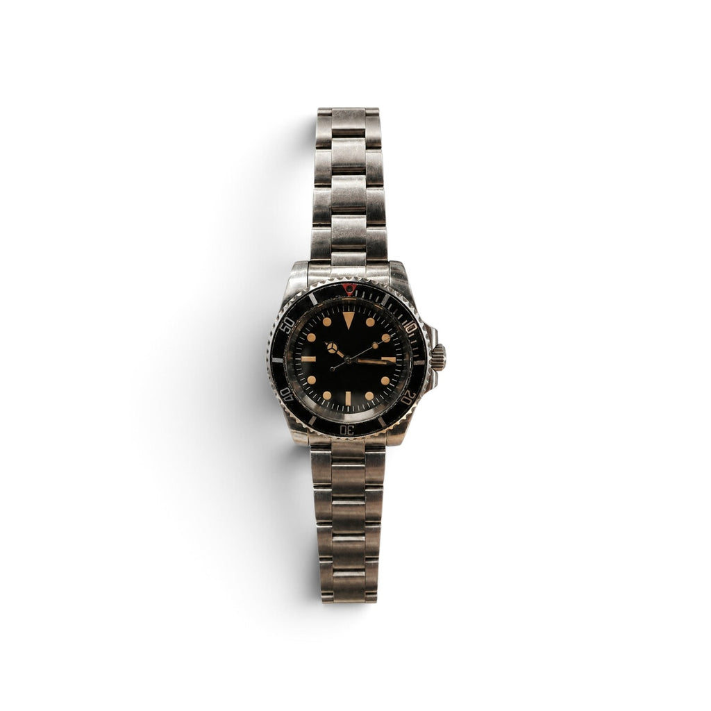 Full view of a 40mm vintage military dive watch on an aged steel bracelet