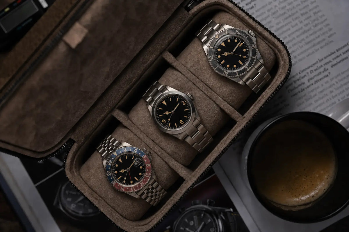 Individually aged vintage-style automatic watches by Vintage Watch Mods. Three custom vintage-style watches featuring a ghost-bezel dive watch, 3-6-9 field watch and red-blue GMT in a watch case.