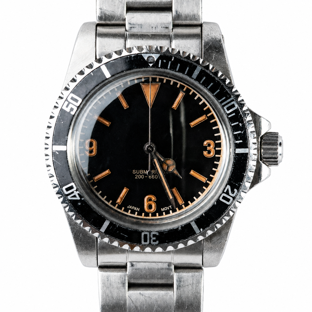 Close-up of an individually aged matte-black 3-6-9 dive watch dial with warm lume