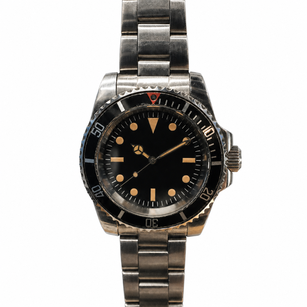 Close-up of an aged matte-black dive-watch dial with warm lume and faded bezel