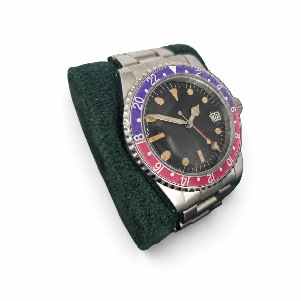 Angled view of the red-blue GMT automatic watch with an aged dial and stainless steel bracelet