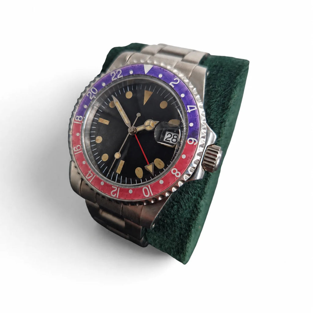 Crown-side view of the vintage red-blue GMT watch showing the date magnifier and aged bezel