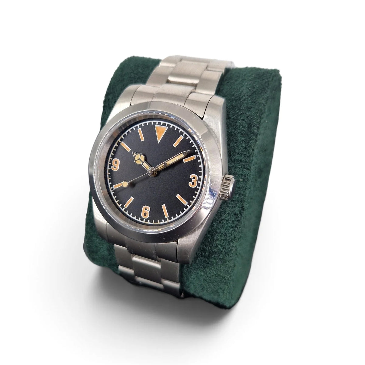 Angled view of a vintage 3-6-9 automatic field watch displayed on a green watch pillow