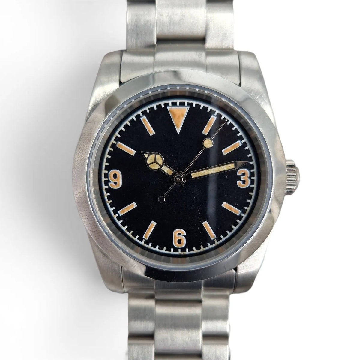 Close-up of the black 3-6-9 dial, aged lume and brushed stainless steel watch case