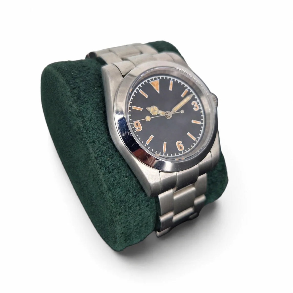 Vintage 3-6-9 automatic field watch displayed at an angle on a green watch pillow