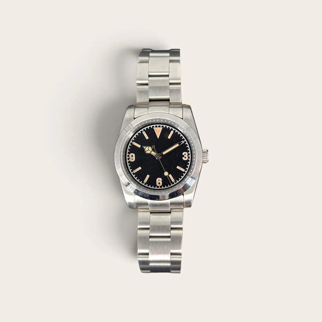 Front view of a 36mm vintage 3-6-9 automatic field watch with black dial and aged lume