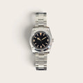 Front view of a 36mm vintage 3-6-9 automatic field watch with black dial and aged lume