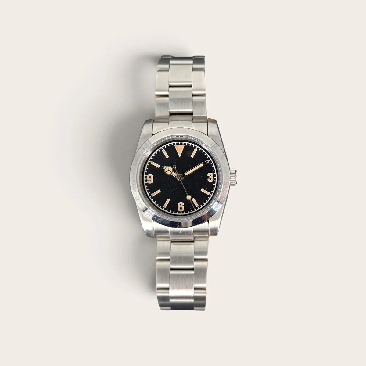 Front view of a 36mm vintage 3-6-9 automatic field watch with black dial and aged lume