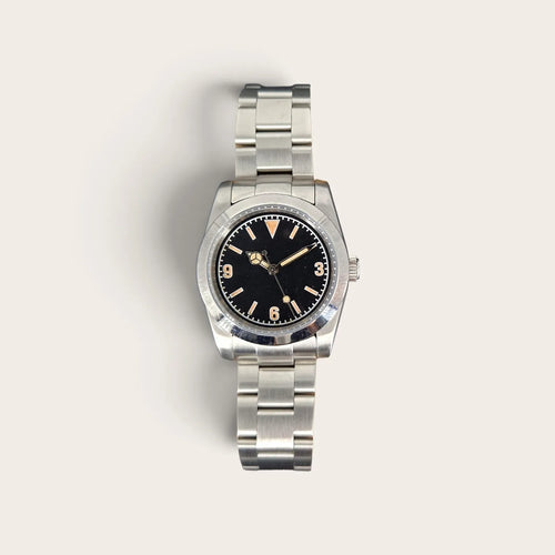 Front view of a 36mm vintage 3-6-9 automatic field watch with black dial and aged lume