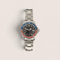 Front view of the vintage red-blue GMT watch with aged bezel, black dial and red GMT hand